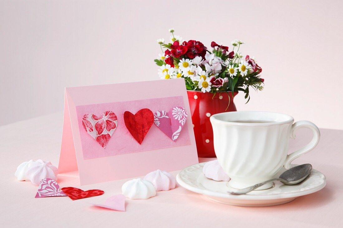 Pink invitation card decorated with paper hearts