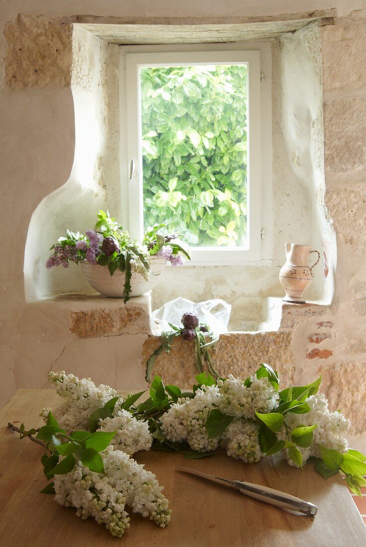Flower arrangement in window niche in Chateau Maignaut (Pyrenees, France)
