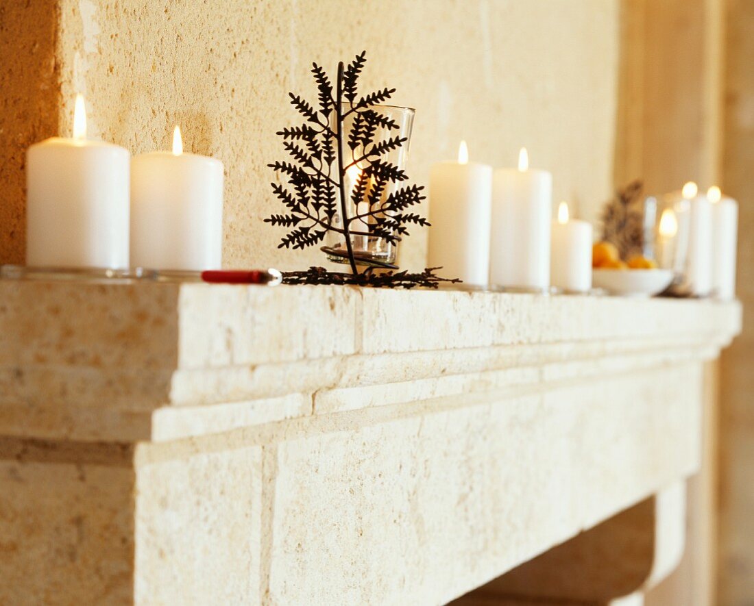 Lit candles on mantelpiece in Château Maignaut (Pyrenees, France)