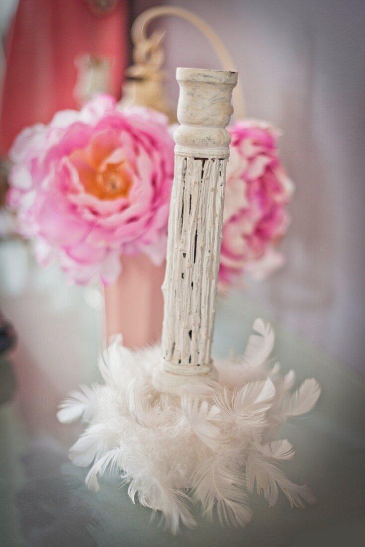 Romantic candlestick in front of peonies