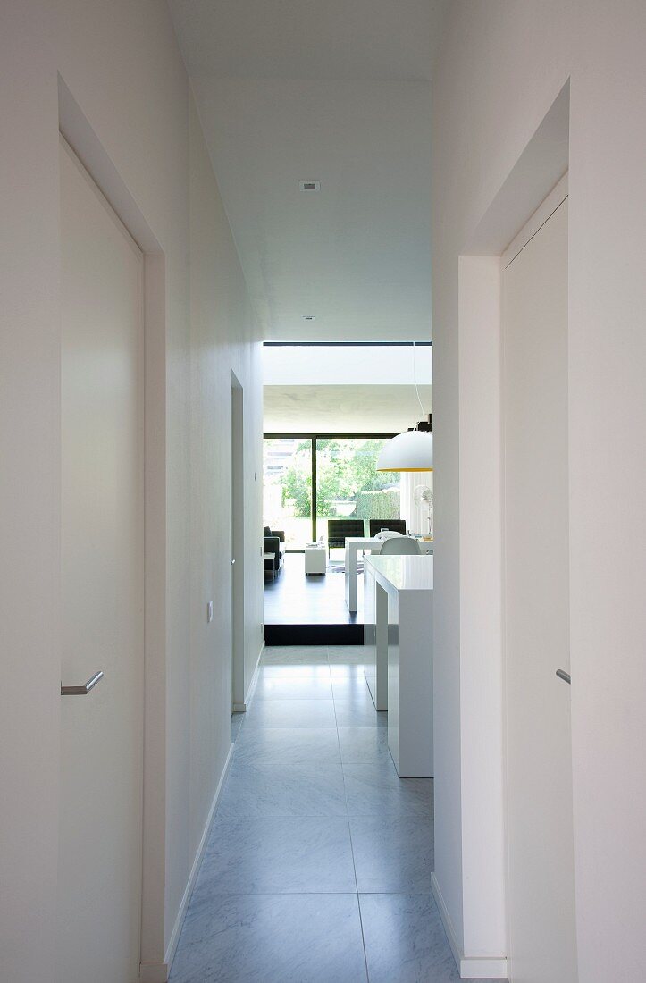 View from corridor into spacious living area with glass wall