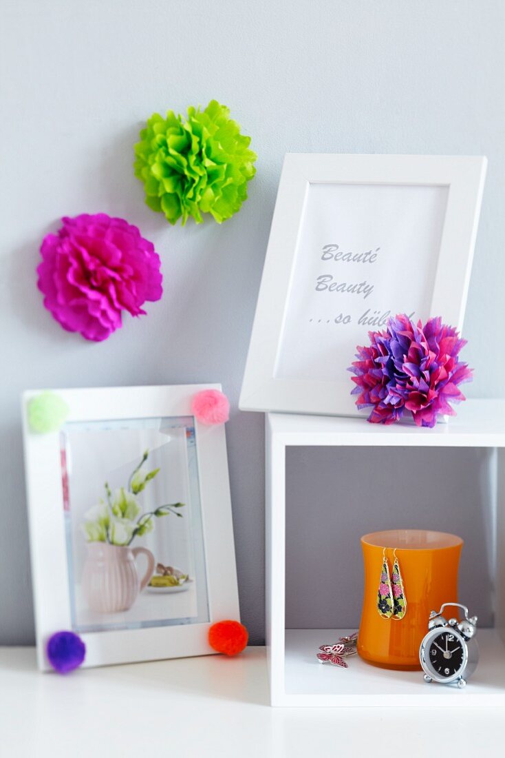 Pompoms decorating picture frames & wall