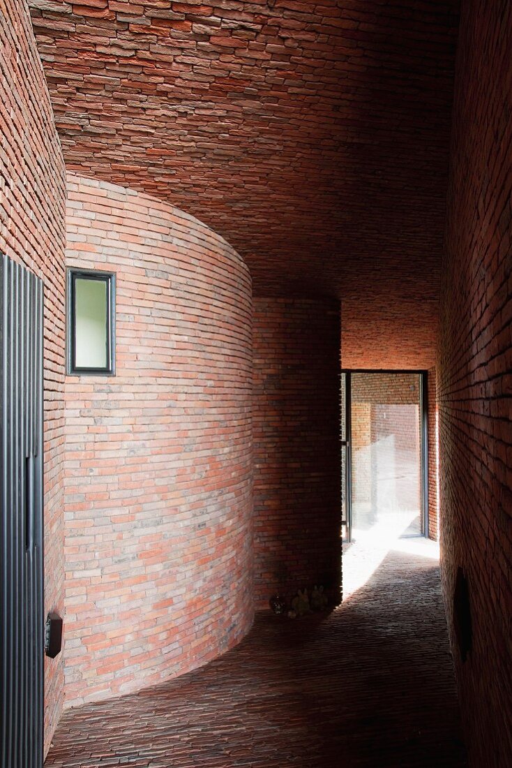 Narrow corridor between brick houses