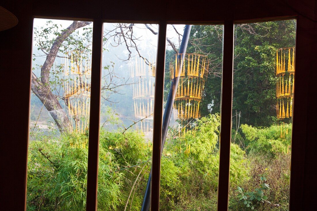Blick durch Fenster in tropischen Garten