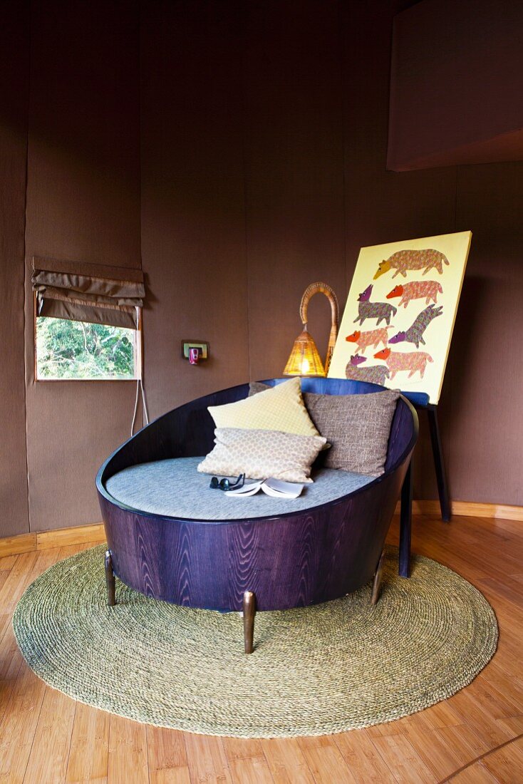 Lounge chair made from purple-stained wooden tub on round rattan rug in corner of room