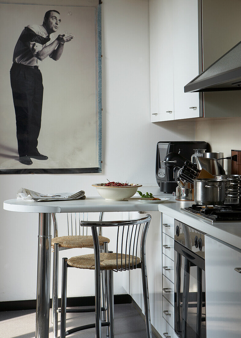 Kitchen with bar stools and large framed art