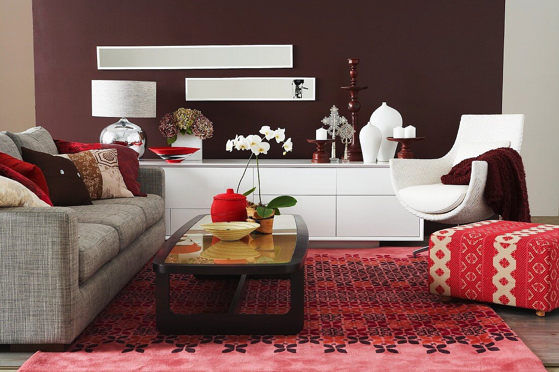 Living room seating area with patterned pink rug and white sideboard with eggshell finish