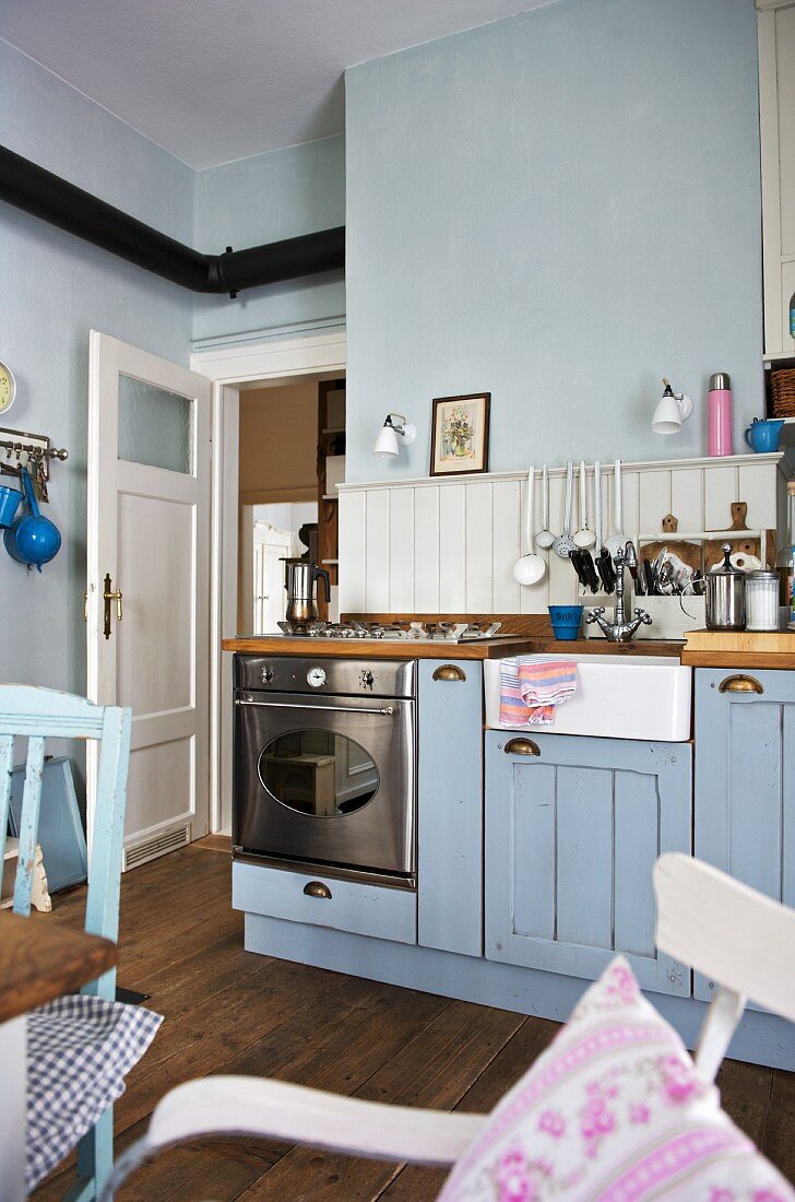 Blaue Landhausküche mit Gasherd und Spülstein aus Keramik