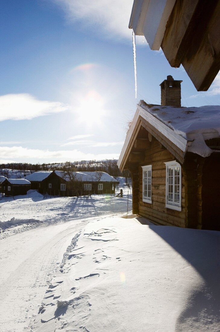 Holzhaussiedlung in verschneiter Winterlandschaft