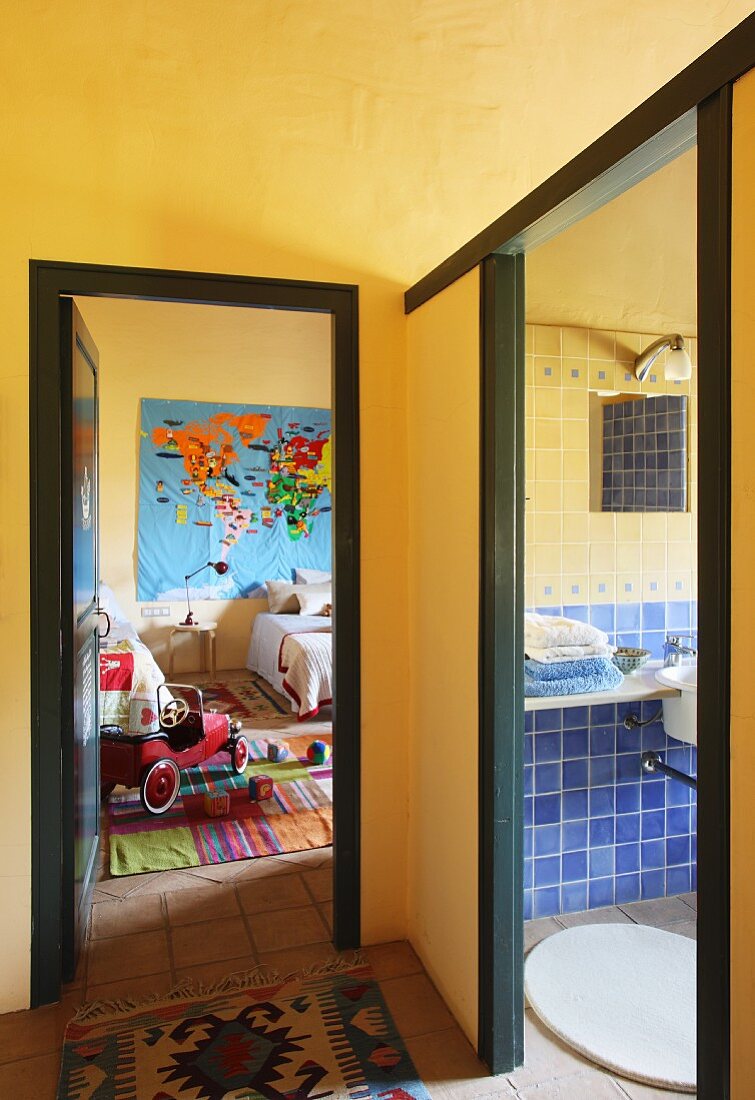Gelb getönte Vorraumecke mit Teppichläufer und Blick durch offene Türen ins Kinderzimmer und Bad