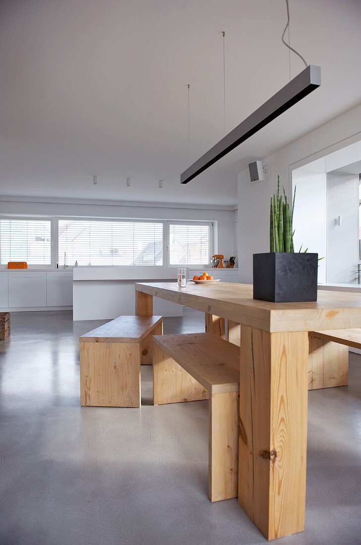 Minimalist wooden table and benches in modern interior