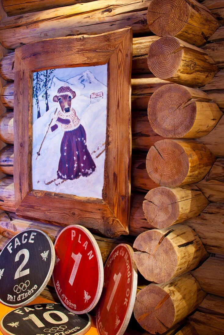 Painting of skiing cow in nostalgic clothing in rustic wooden frame