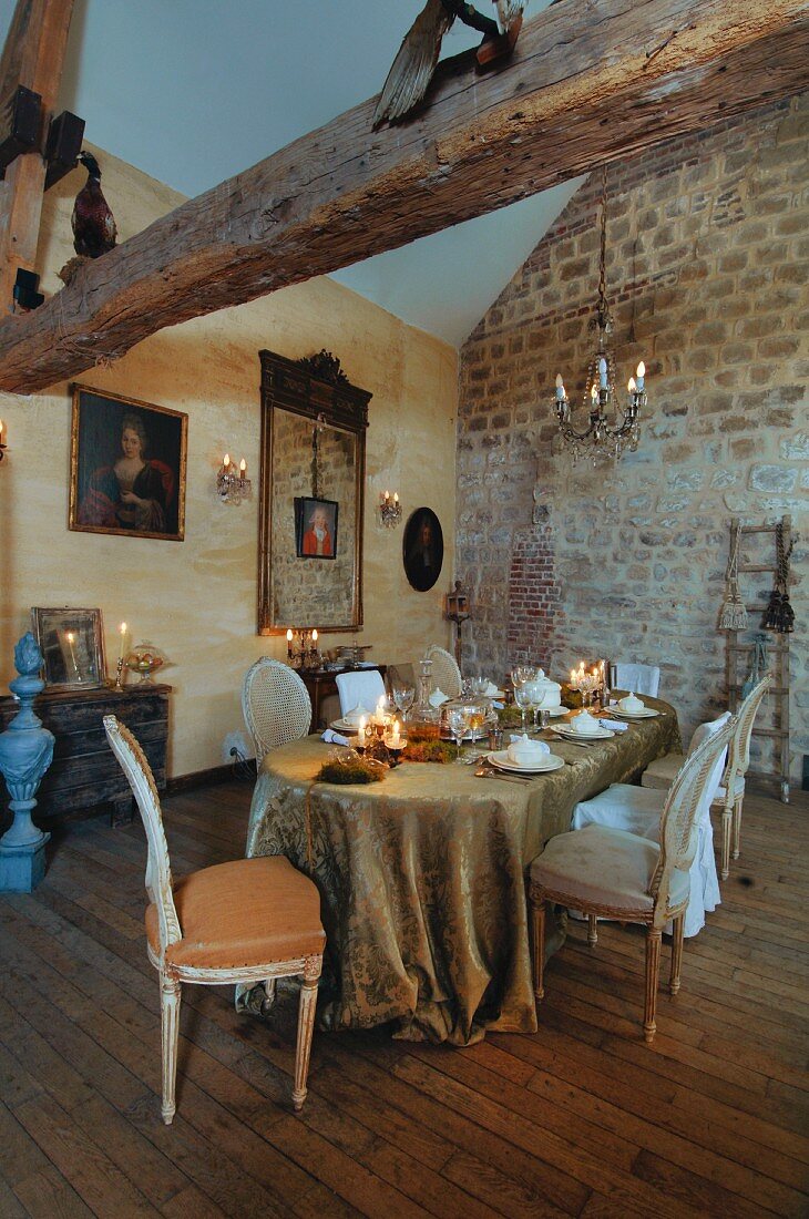 Long table festively set in stylish, vintage Rococo style in old, French country hose