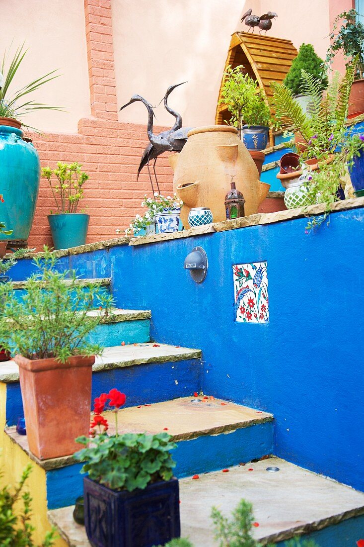 Original courtyard with colourful steps and potted plants