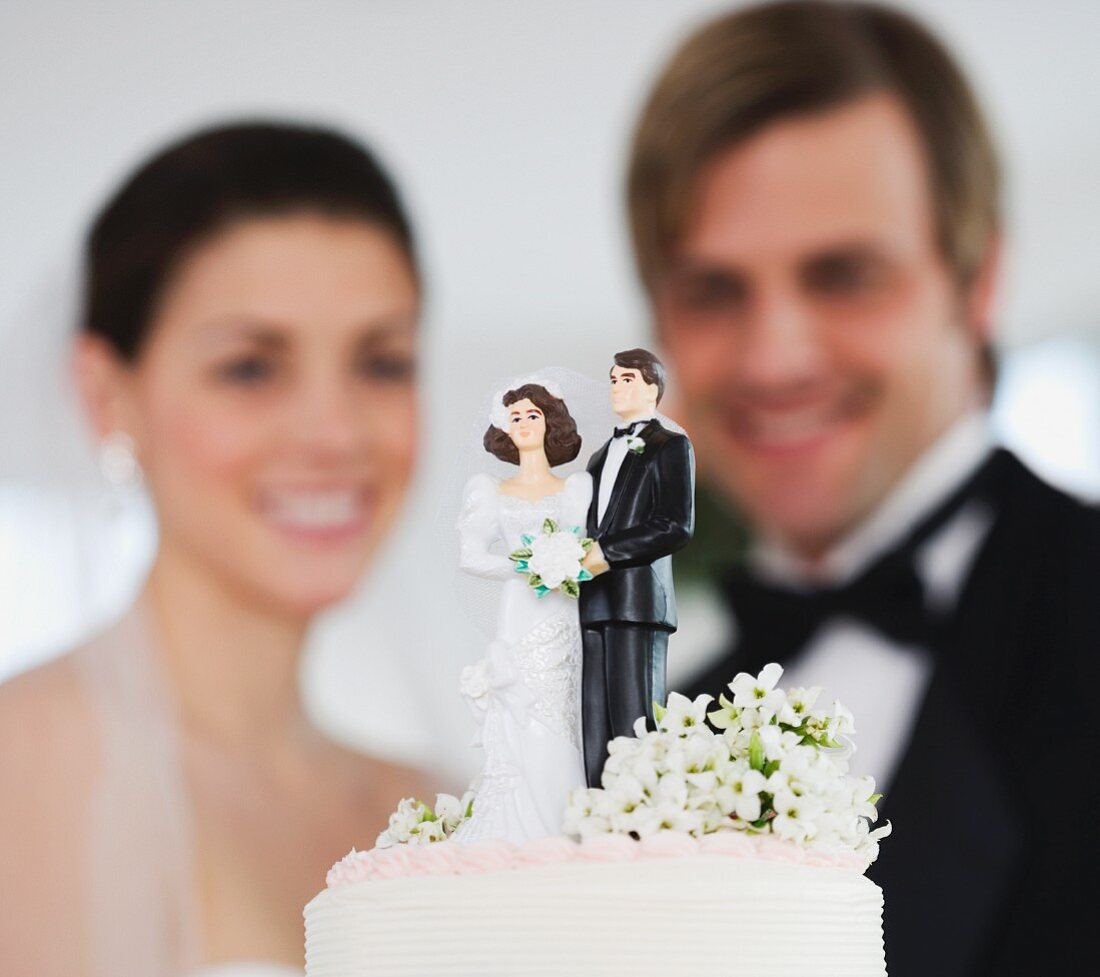 Bride and groom smiling at wedding cake