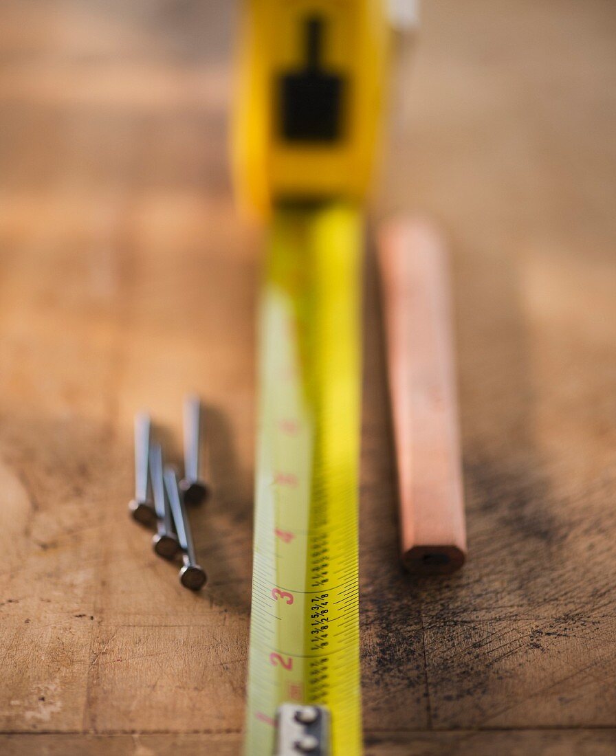 Tape measure, nails and pencil