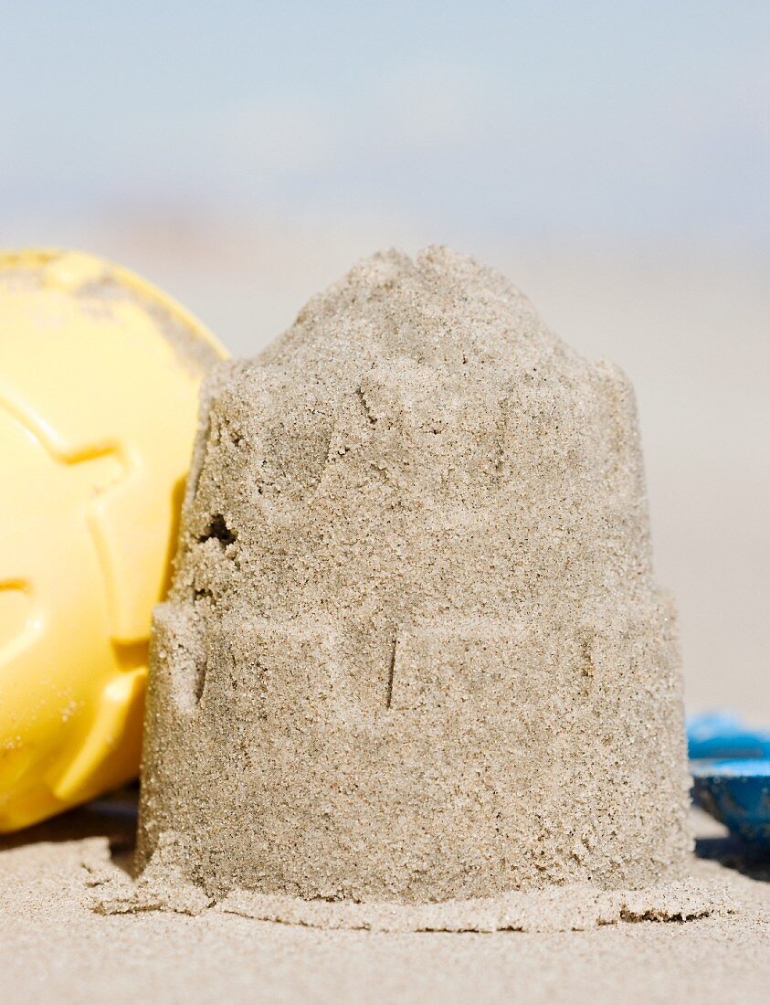 Sand castle mold on beach