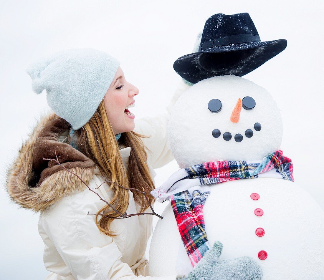 Profile of young woman with snowman