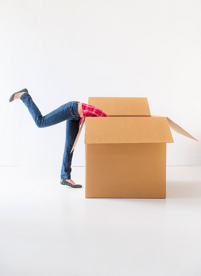 Studio shot of young woman looking into box