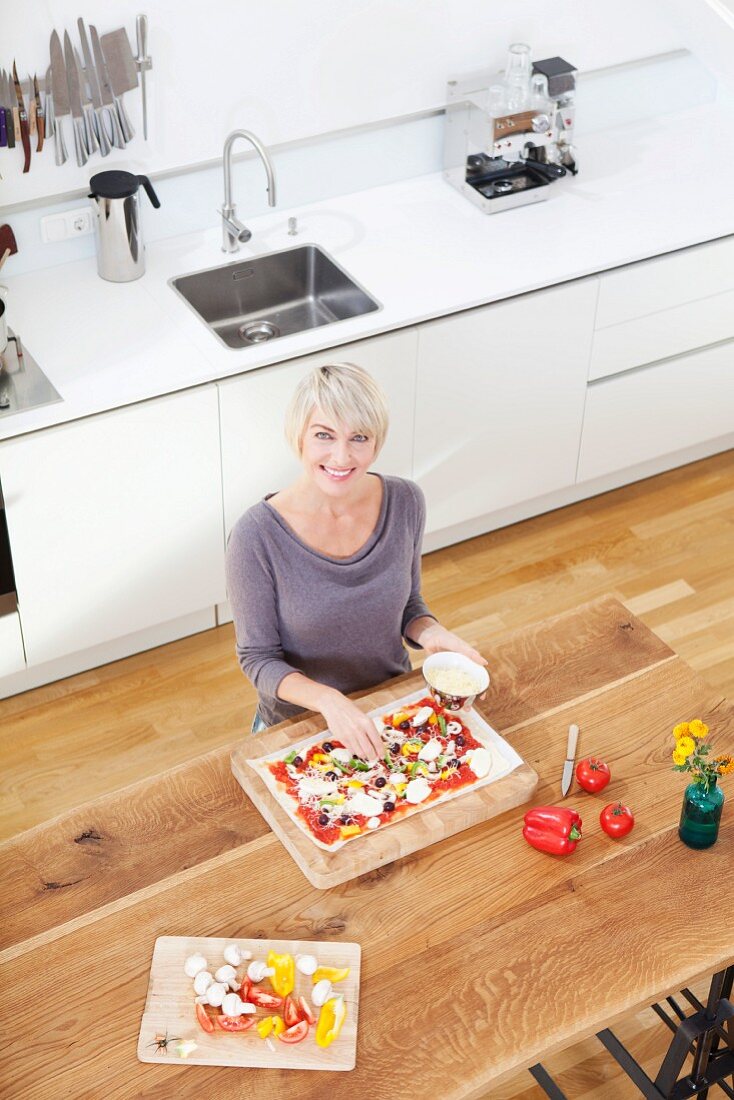Frau bereitet Pizza zu