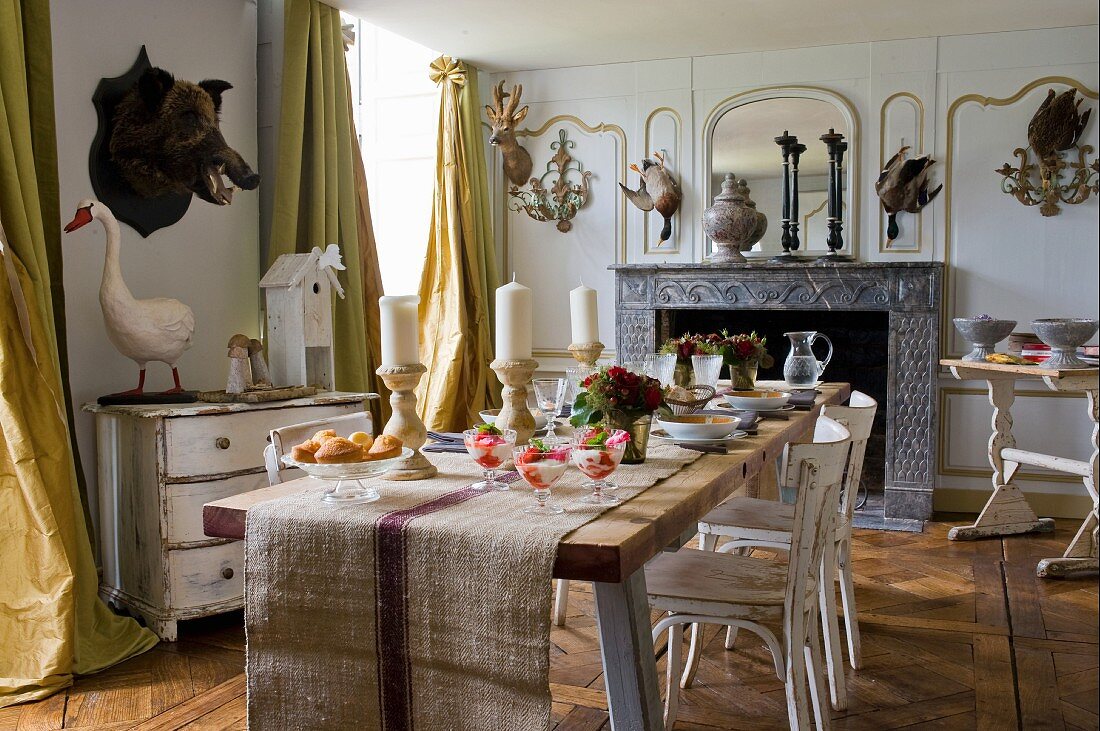 Set table in rustic dining room with various animal trophies on walls