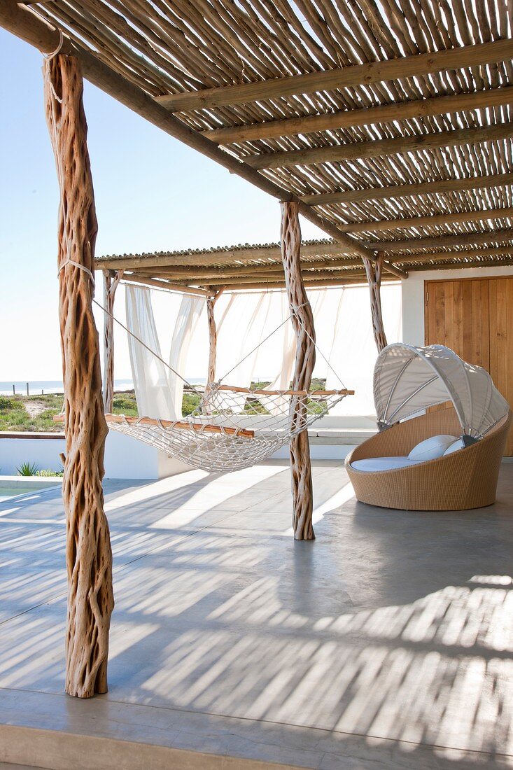 Sun terrace with rustic sun shade, mesh hammock and wide ocean vista
