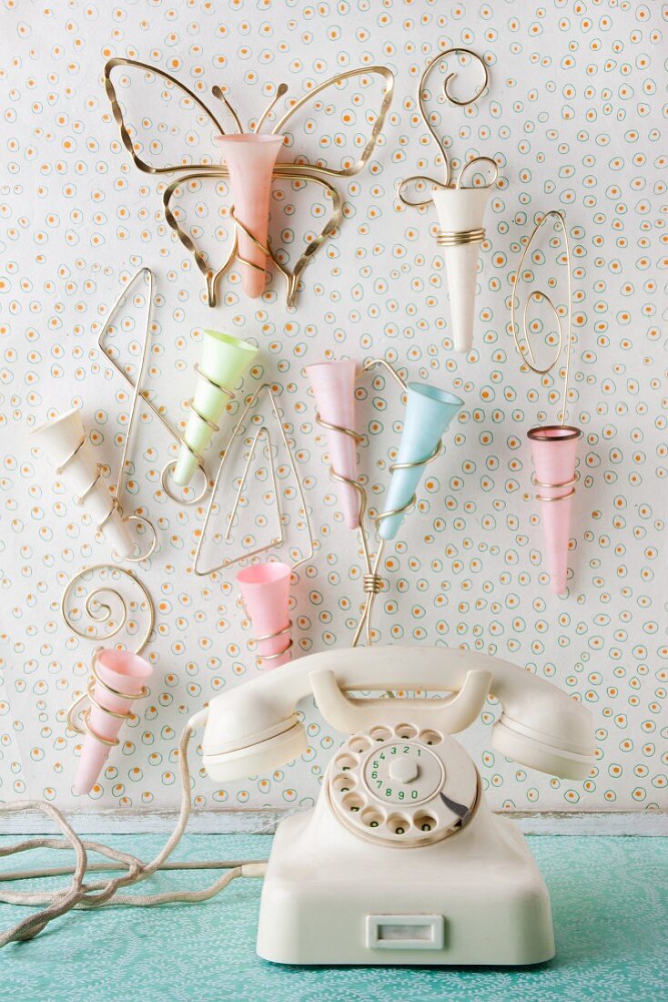 White, retro telephone and collection of 50s wall vases