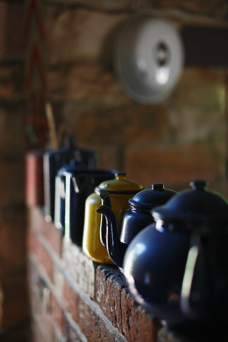 Collection of vintage metal teapots in different colours