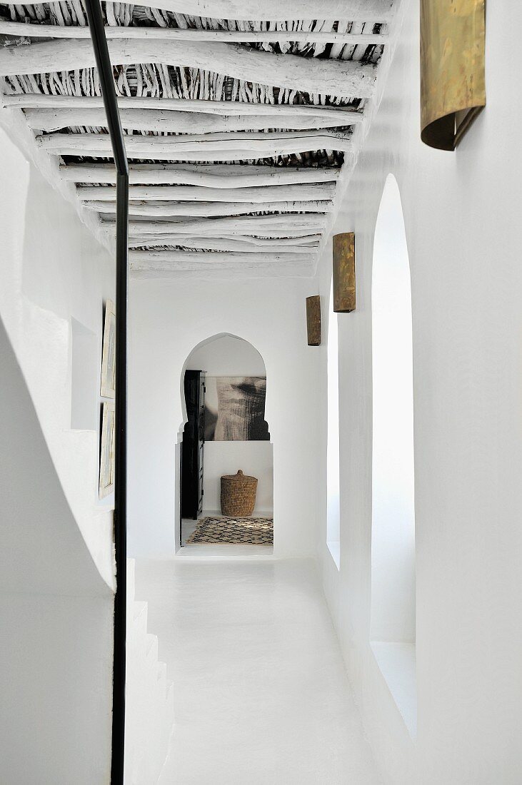 Hallway with Moroccan wooden roof structure and Moorish arch at far end