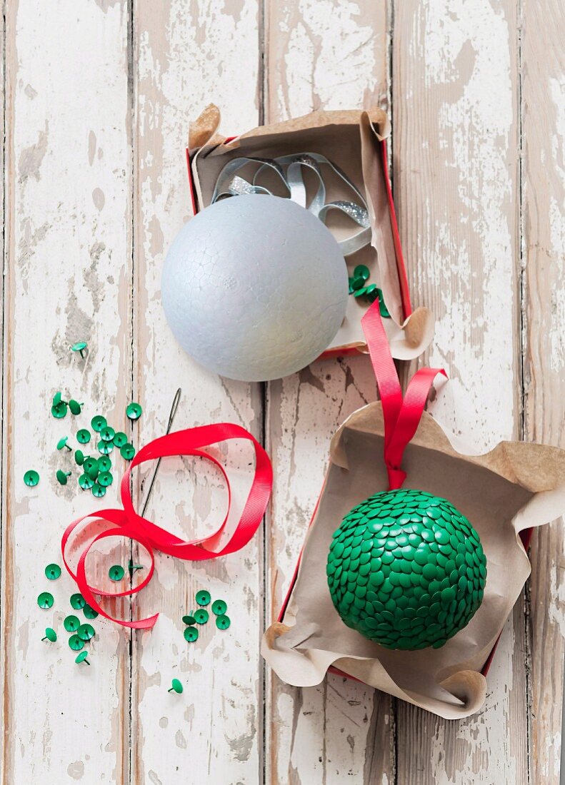 Hand-crafted Christmas tree decorations made from polystyrene balls and green drawing pins
