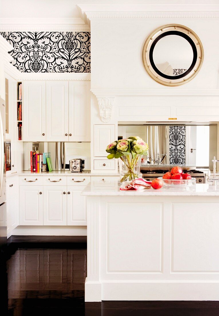 White, traditional-style fitted cupboards with integrated serving hatch to postmodern dining room