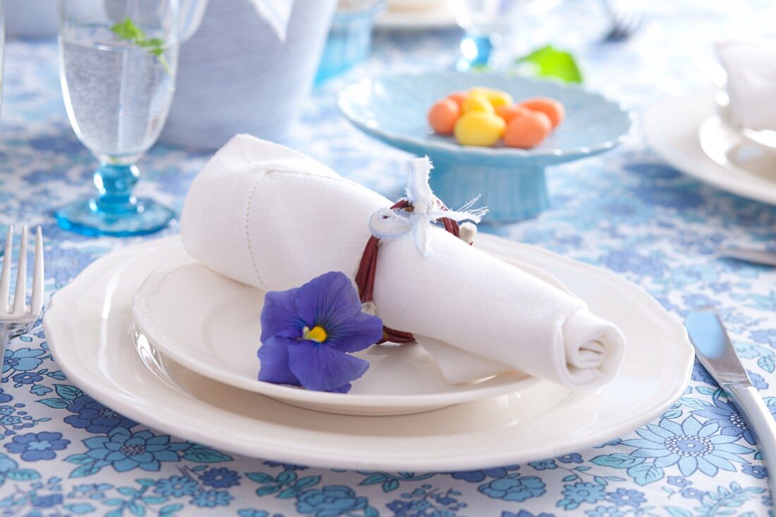 Easter place setting with willow-twig napkin ring and blue pansy