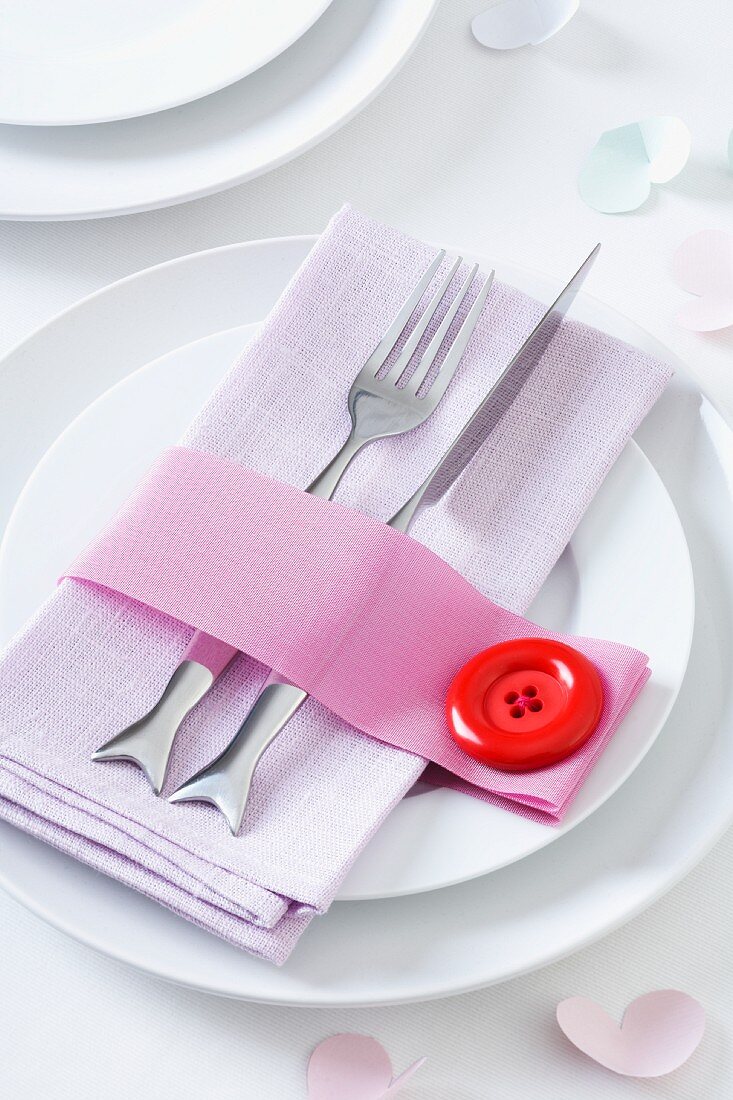 Ribbon napkin ring with oversize clown button decorating table