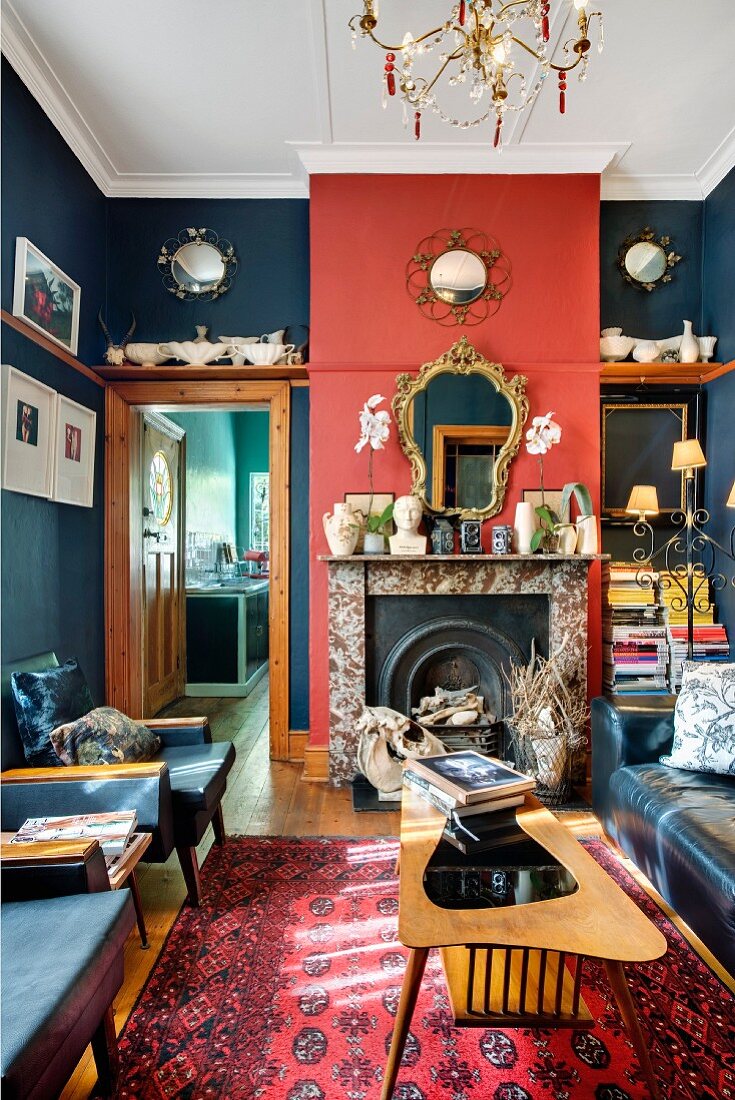 Red and blue living room with retro furniture, collectors' items and open fireplace