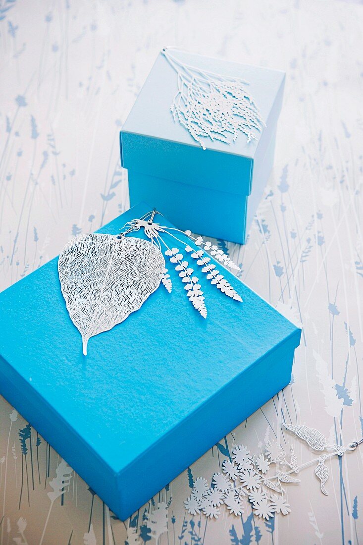 Finely carved leaf motifs decorating blue gift boxes