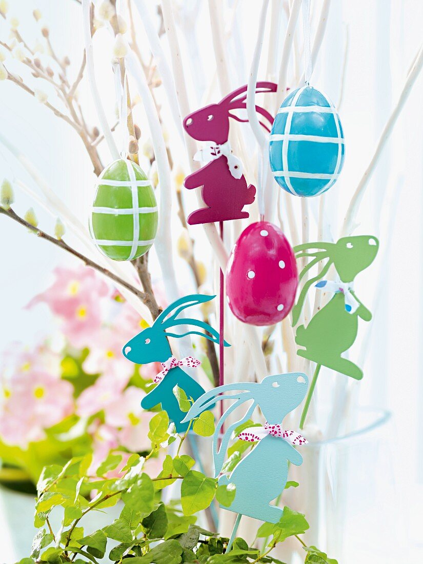 Easter decorations hanging from twigs in flower pot