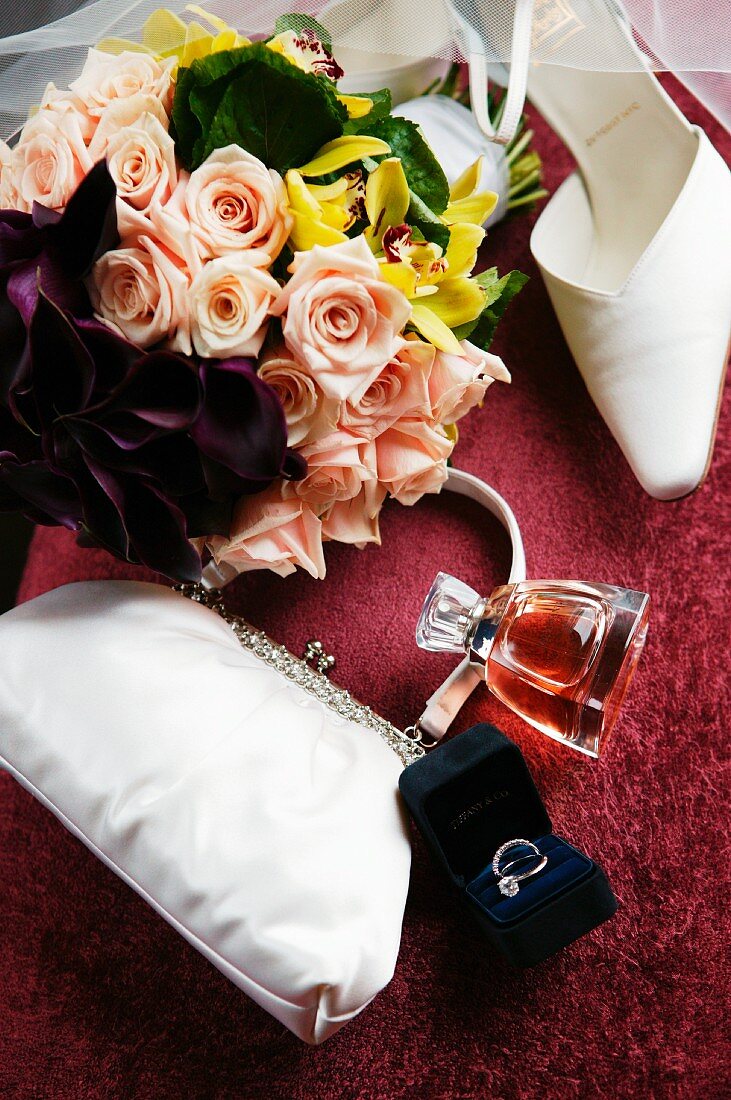 White bridal bag, rings, perfume, shoes and bouquet