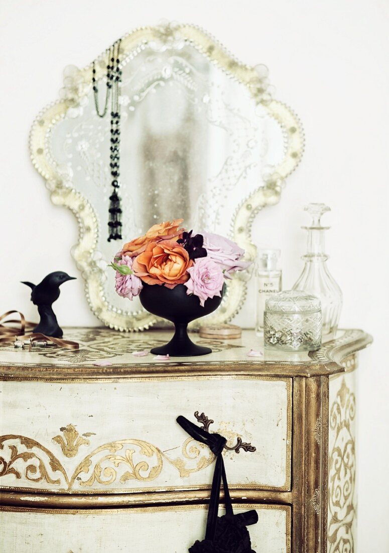 Antique chest of drawers with romantic mirror & bouquet of roses of the varieties 'Lady Emma Hamilton' (orange) and 'Novalis' (pink)