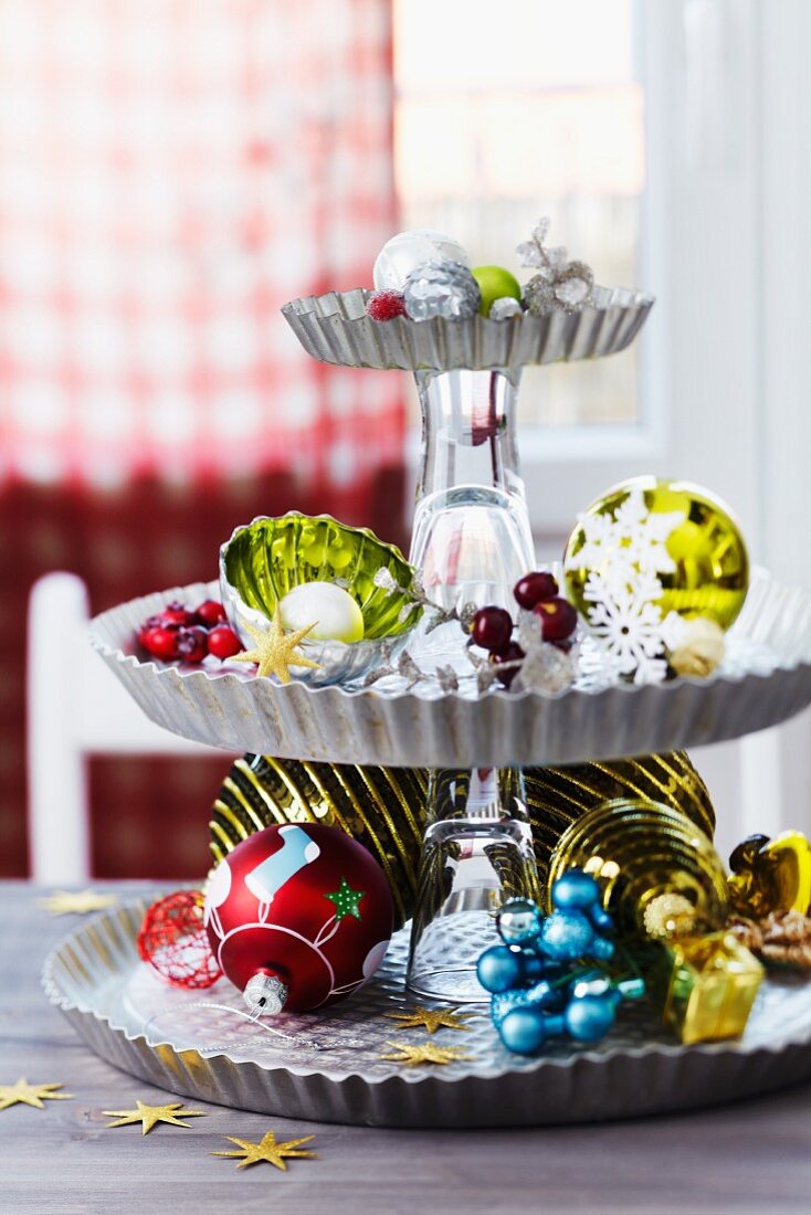 Arrangement of Christmas decorations on cake stand upcycled from tart tins