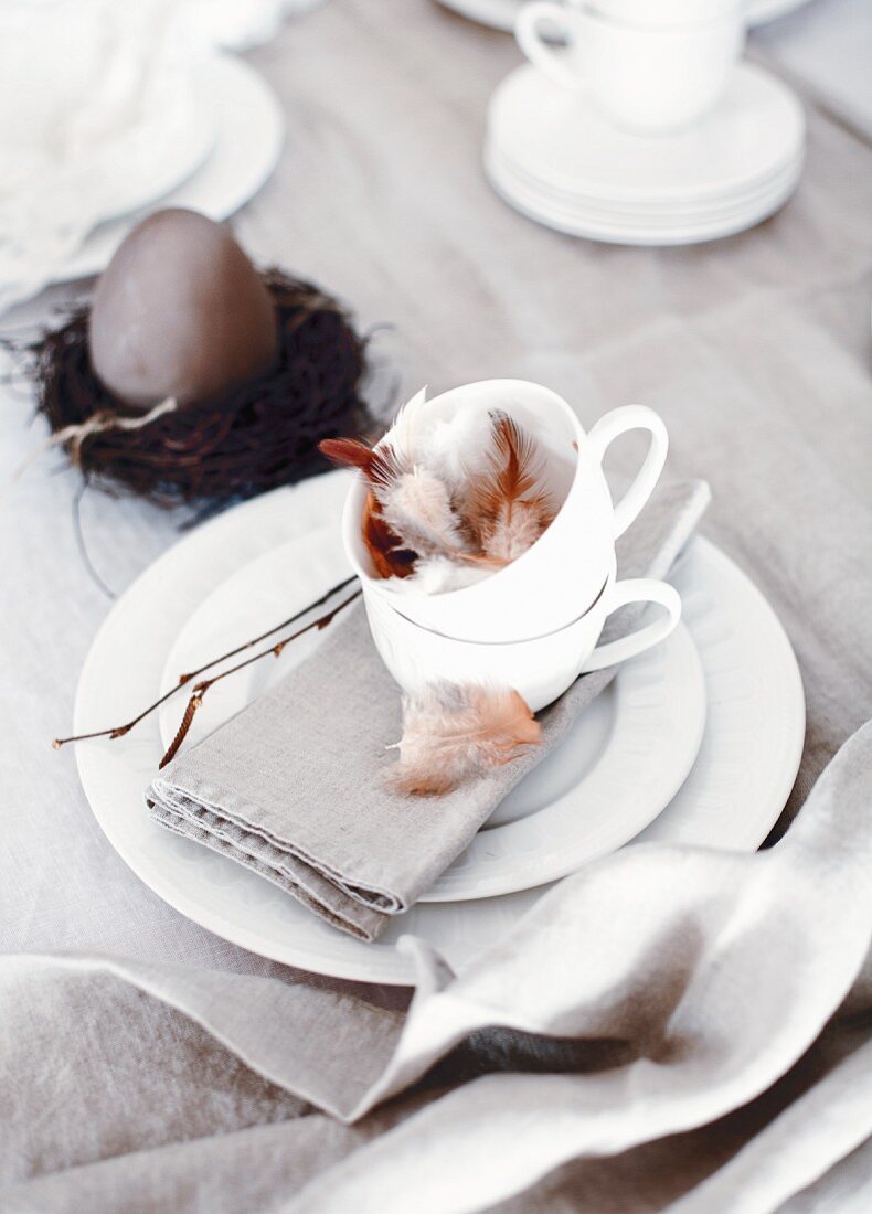 Easter place setting with feathers in cup
