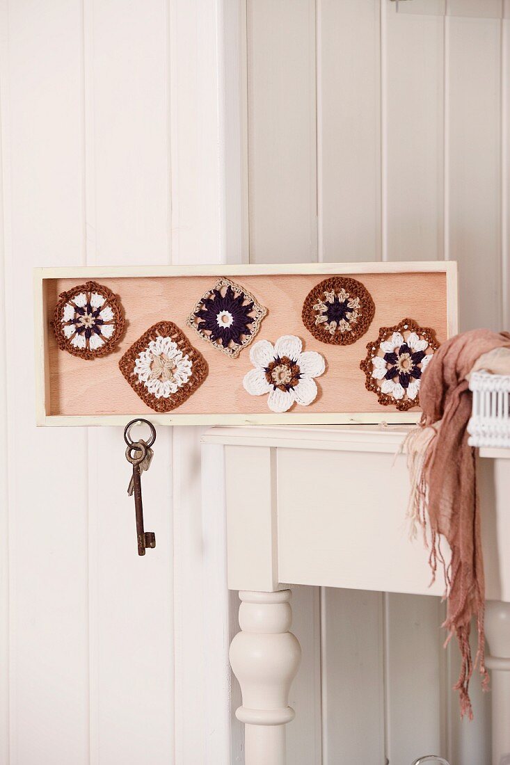 Home-made key rack decorated with crocheted doilies