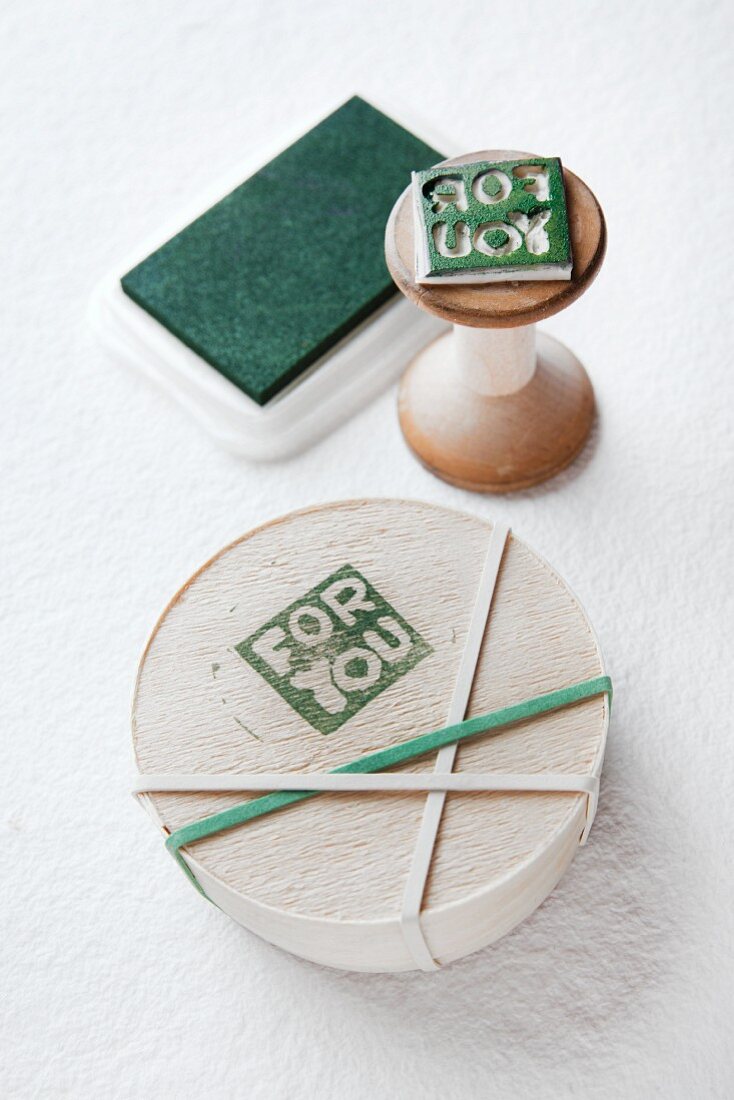 Chip wood box with printed motif reading 'For you'; hand-carved rubber stamp on wooden handle and ink pad in background