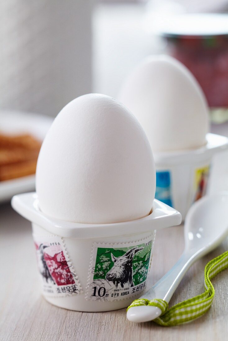 Egg cups decorated with postage stamps