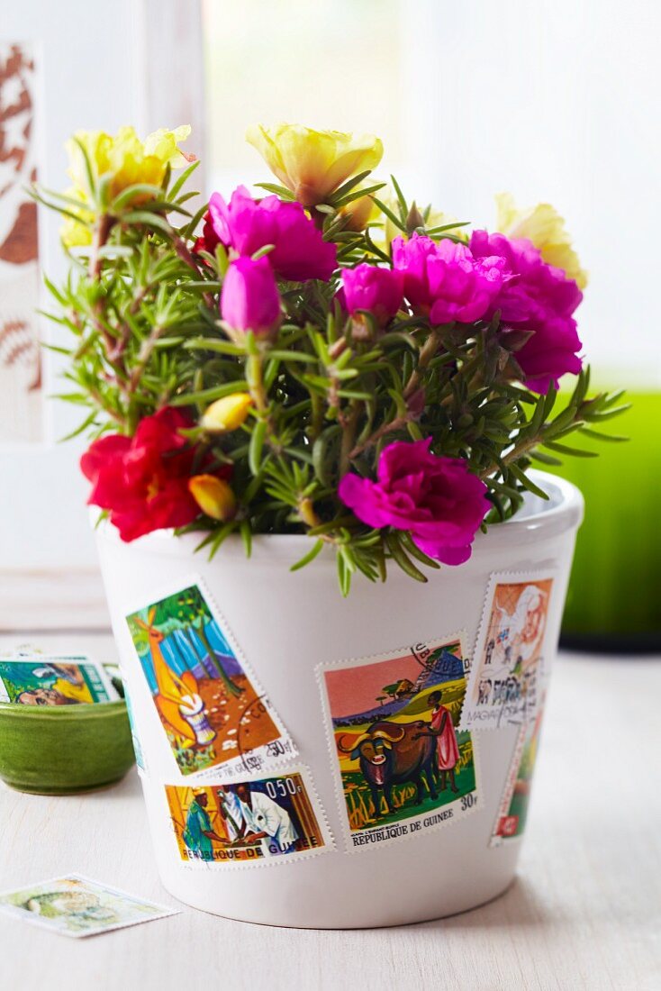Plant pot decorated with postage stamps