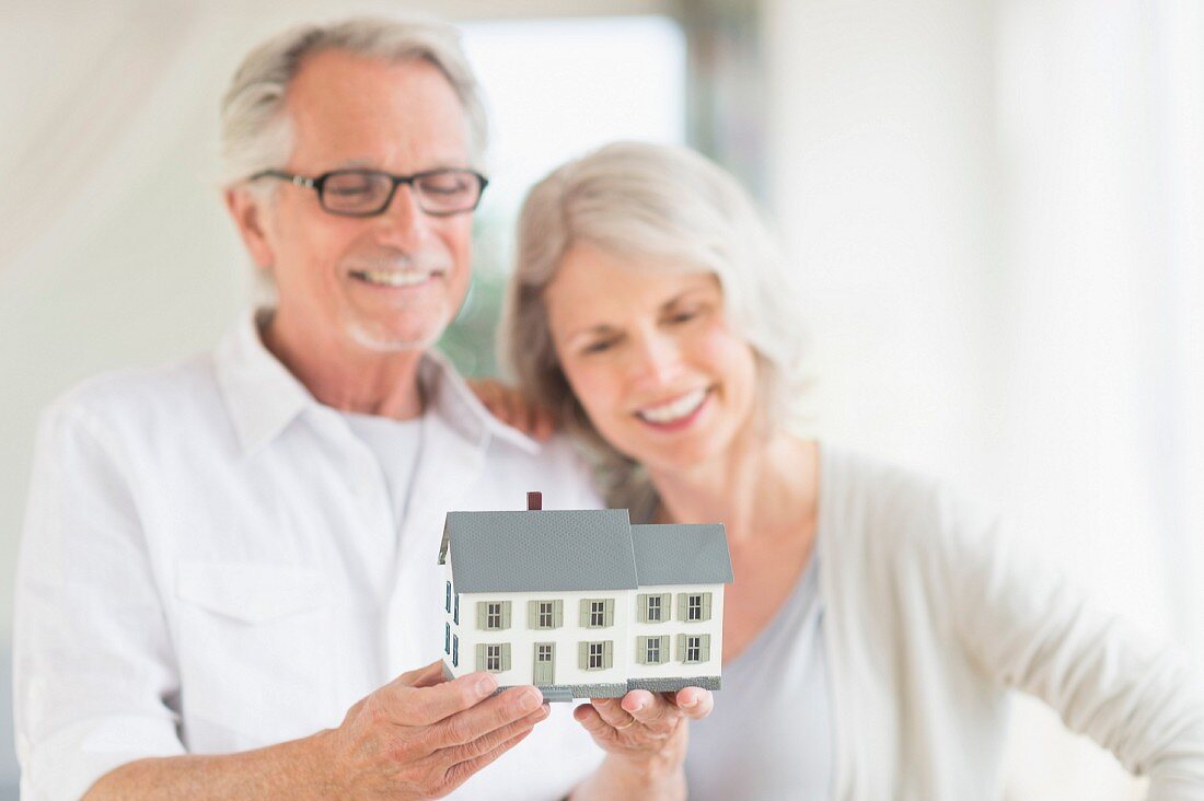 Older couple looking at model of house