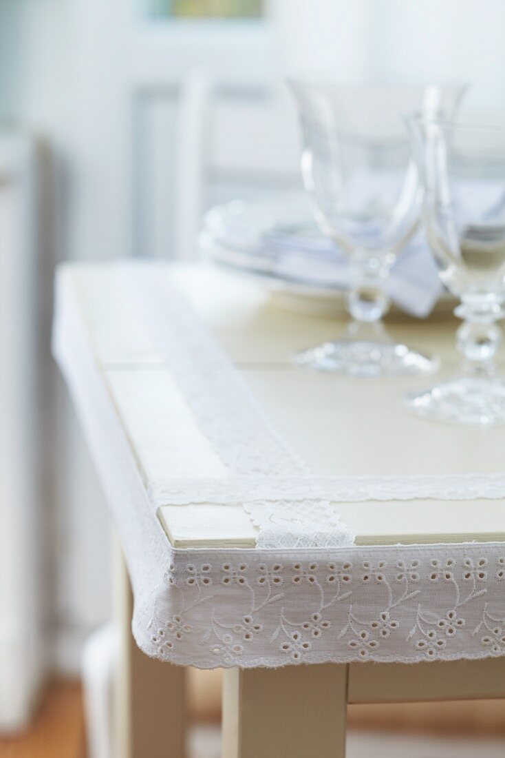 Dining table decorated with white lace ribbon