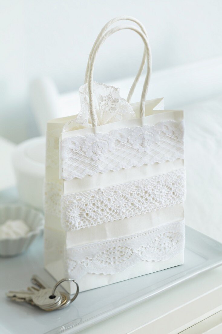 Gift bag decorated with various lace ribbons