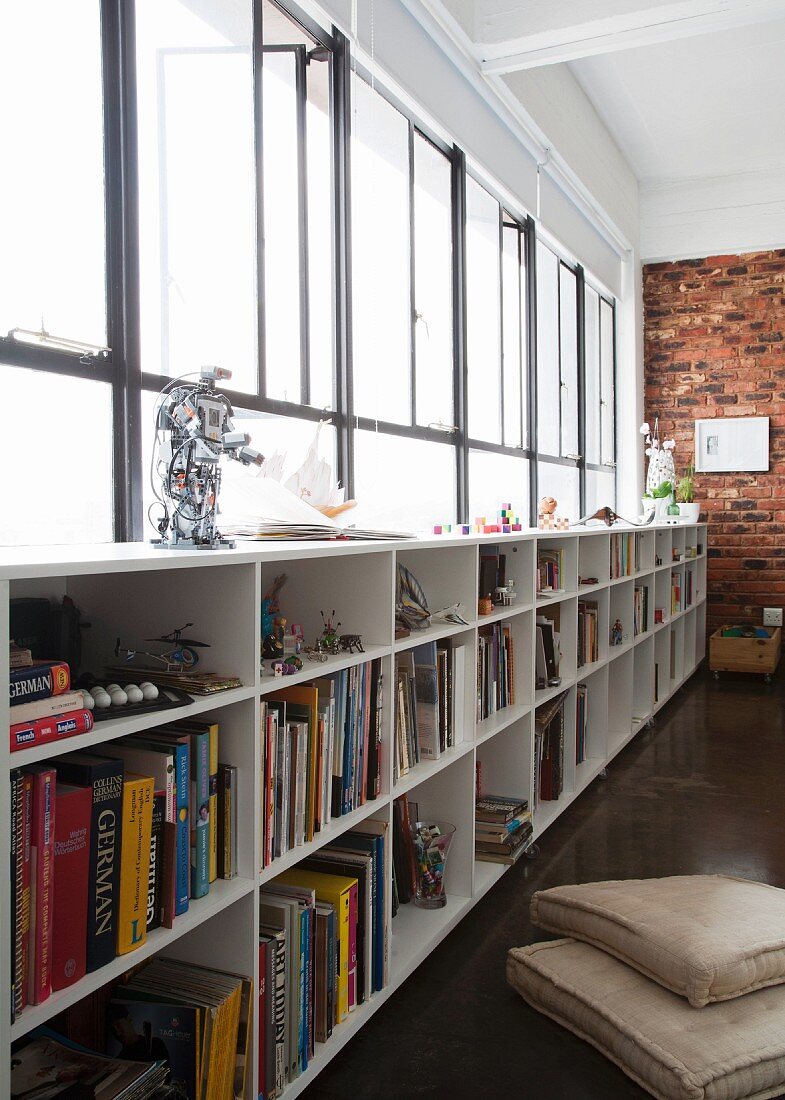 Half-height bookcase below entire length of ribbon window