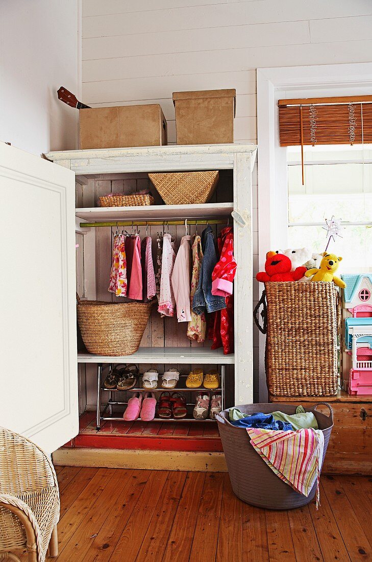 Wardrobe with shoe rack and storage baskets for laundry and toys