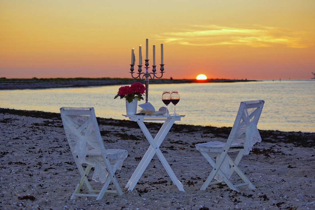 Romantic candlelight dinner on beach at sunset